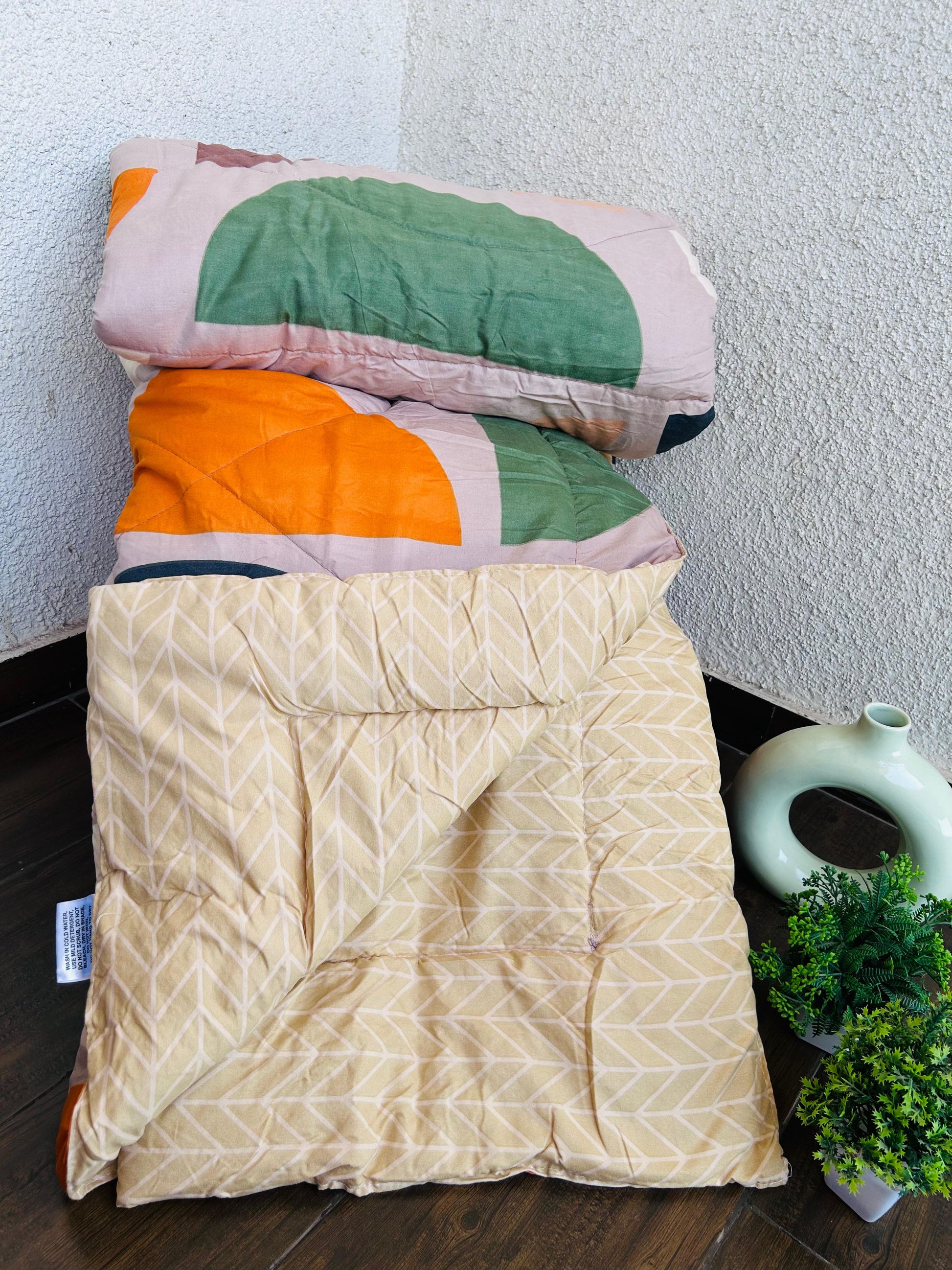 Stack of folded blankets with geometric patterns